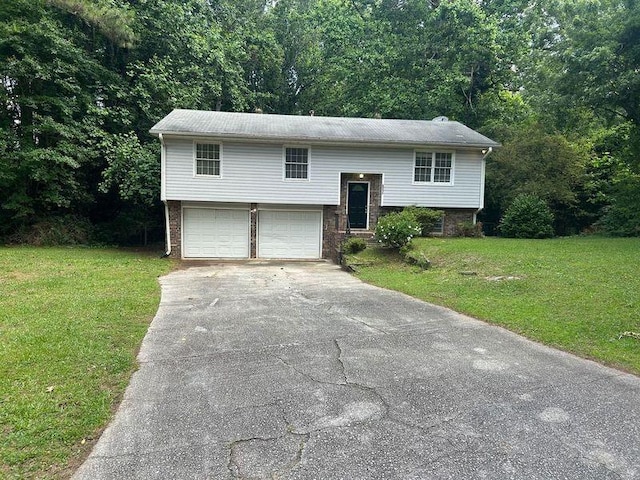 6956 Kimberland Gardens Ln, Lithonia, GA 30058 - bi-level home featuring driveway, a front lawn, brick siding, and a garage