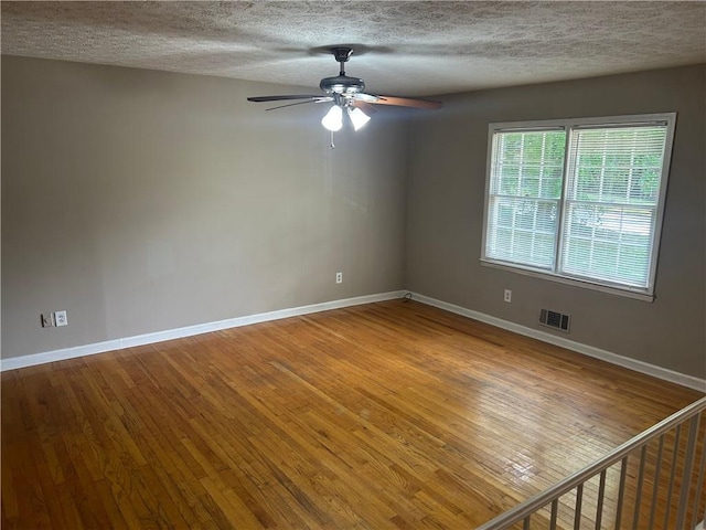 6956 Kimberland Gardens Ln, Lithonia, GA 30058 - unfurnished room with wood finished floors, baseboards, a ceiling fan, and a textured ceiling