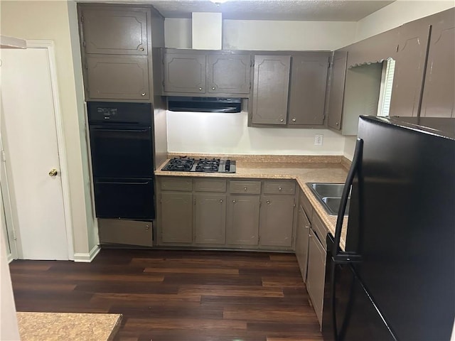 6956 Kimberland Gardens Ln, Lithonia, GA 30058 - kitchen with black appliances, gray cabinetry, ventilation hood, and dark wood-style floors