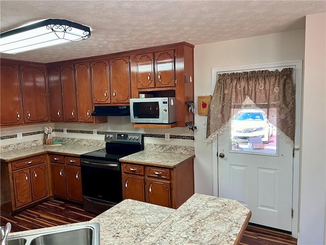 kitchen with stainless steel electric range oven, dark hardwood / wood-style floors, sink, and a textured ceiling