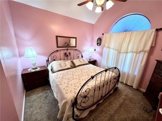 carpeted bedroom with vaulted ceiling and ceiling fan