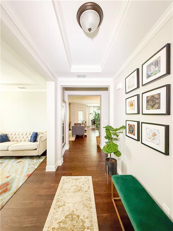 810 Pressing Dr, Alpharetta, GA 30004 - hall featuring a tray ceiling, dark wood-style flooring, crown molding, and baseboards