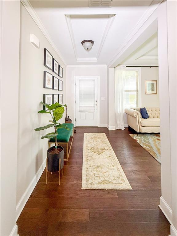 810 Pressing Dr, Alpharetta, GA 30004 - foyer with baseboards, a tray ceiling, dark wood-type flooring, and ornamental molding