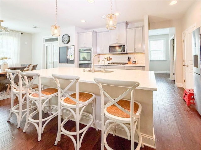 810 Pressing Dr, Alpharetta, GA 30004 - kitchen featuring appliances with stainless steel finishes, a sink, recessed lighting, dark wood finished floors, and decorative light fixtures