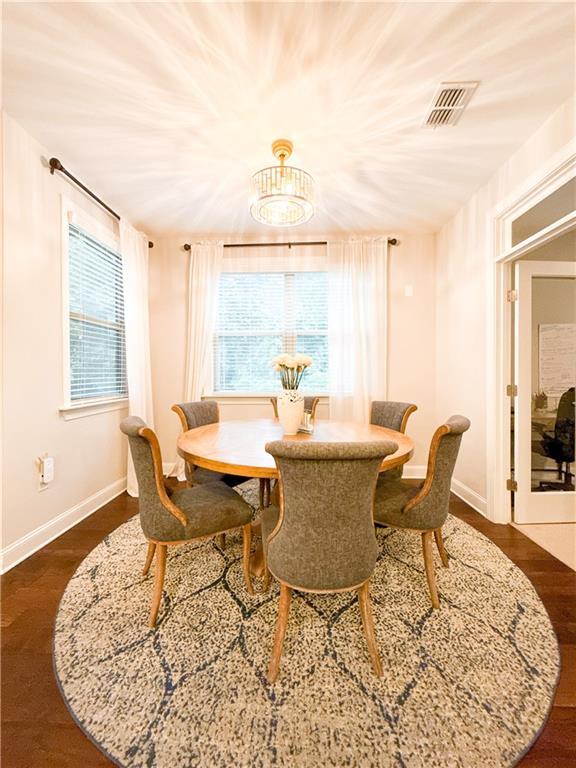 810 Pressing Dr, Alpharetta, GA 30004 - dining room with dark wood finished floors, baseboards, and a chandelier