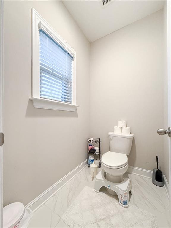 810 Pressing Dr, Alpharetta, GA 30004 - bathroom with toilet, marble look tile flooring, and baseboards