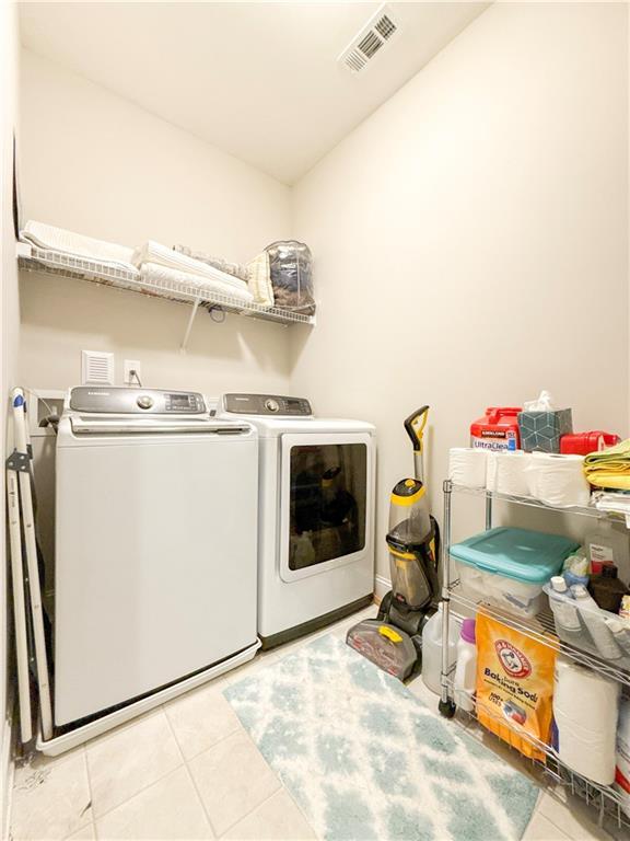 810 Pressing Dr, Alpharetta, GA 30004 - laundry room with washing machine and clothes dryer and tile patterned flooring
