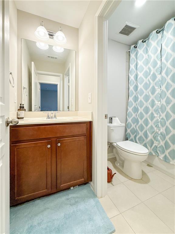 810 Pressing Dr, Alpharetta, GA 30004 - full bath with toilet, vanity, tile patterned floors, and a shower with shower curtain