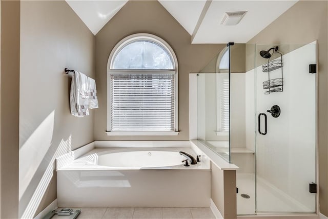 bathroom with separate shower and tub, tile patterned flooring, and vaulted ceiling