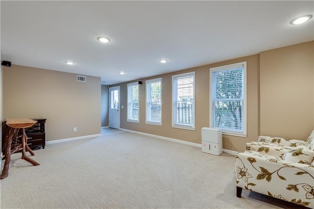 living area with light carpet