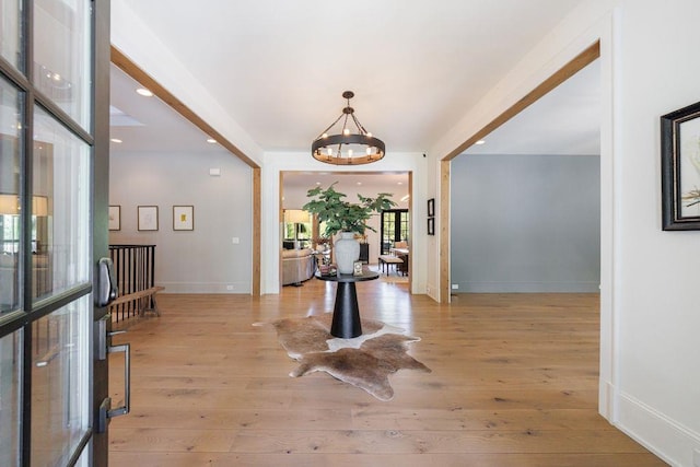 entrance foyer featuring baseboards, wood finished floors, an inviting chandelier, and recessed lighting
