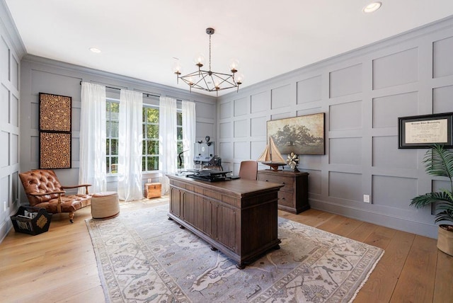 office featuring recessed lighting, a decorative wall, a chandelier, and light wood-style floors