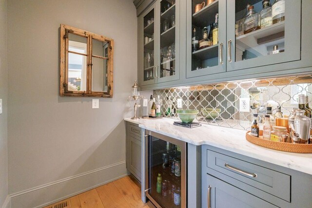 1530 Redd Rd, Milton, GA 30004 - kitchen with light wood-type flooring, white cabinetry, decorative backsplash, built in refrigerator, and light countertops
