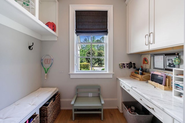interior space featuring light wood finished floors and baseboards