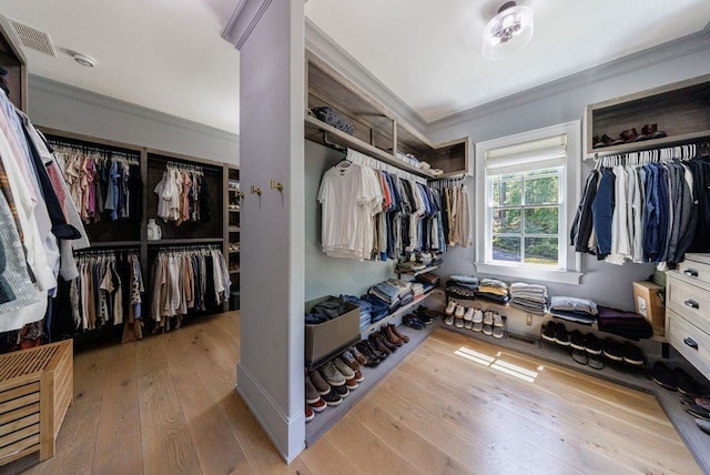 walk in closet featuring hardwood / wood-style floors and visible vents