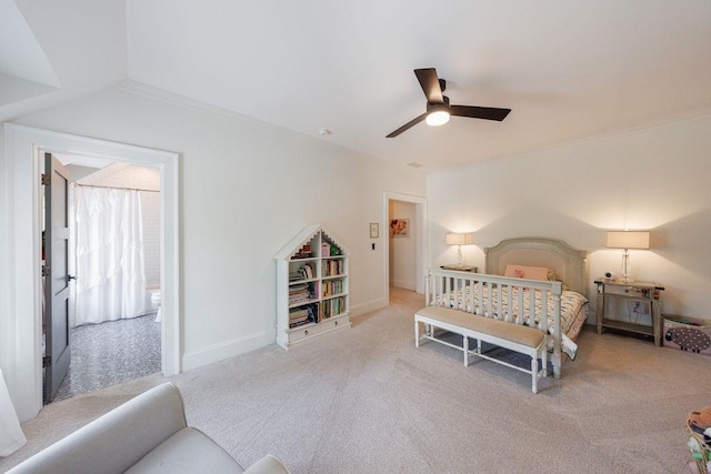 carpeted bedroom with a ceiling fan, baseboards, crown molding, and ensuite bathroom