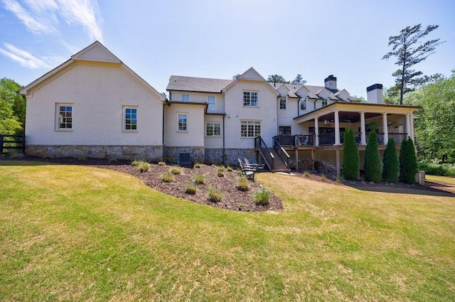back of house with stairs, a lawn, a chimney, and a deck