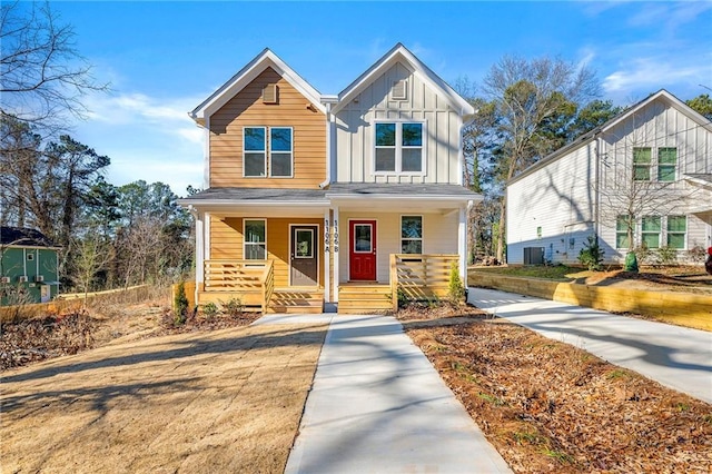 view of front of home with central air condition unit, covered porch, and board and batten siding