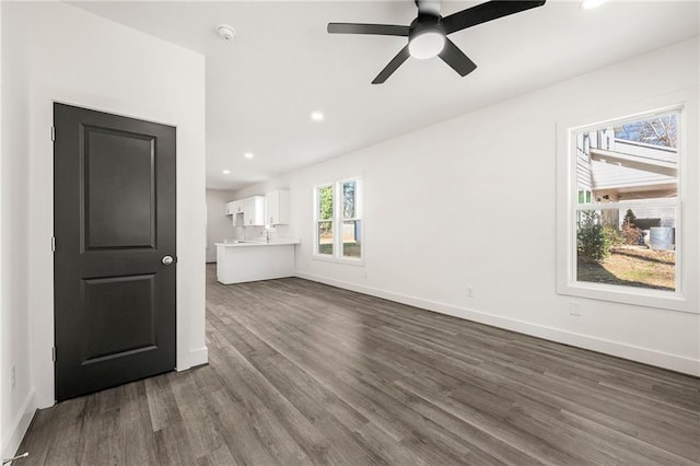 unfurnished living room featuring recessed lighting, dark wood-style floors, baseboards, and ceiling fan