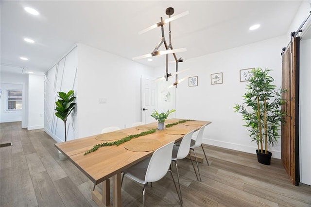 dining room featuring hardwood / wood-style floors and a barn door