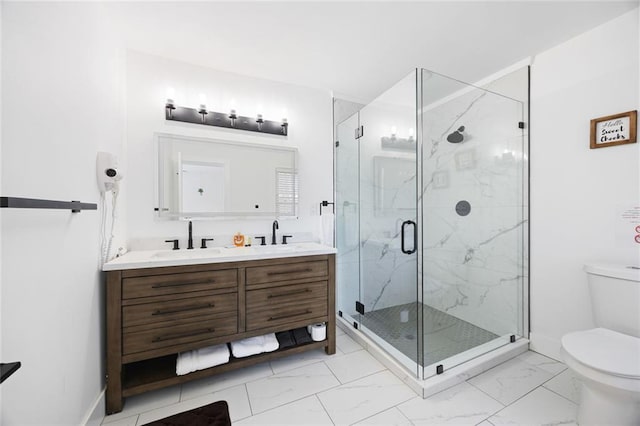 bathroom featuring vanity, toilet, and a shower with shower door