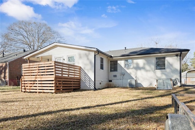 rear view of property with a lawn and a deck