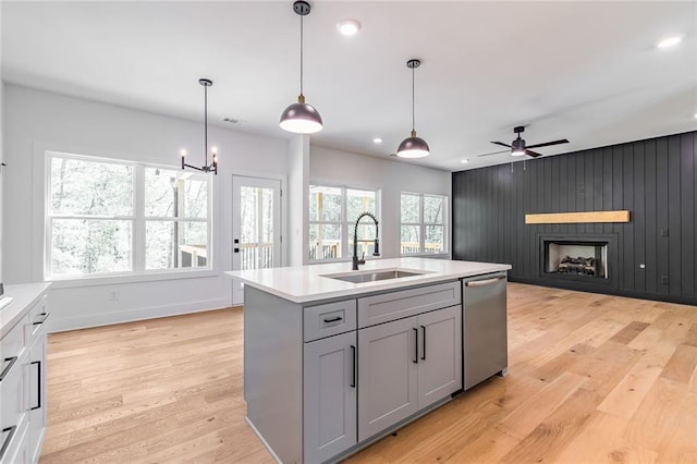 6073 Rockingham Way, Gainesville, GA 30506 - kitchen with light wood-type flooring, light countertops, a sink, dishwasher, and gray cabinetry
