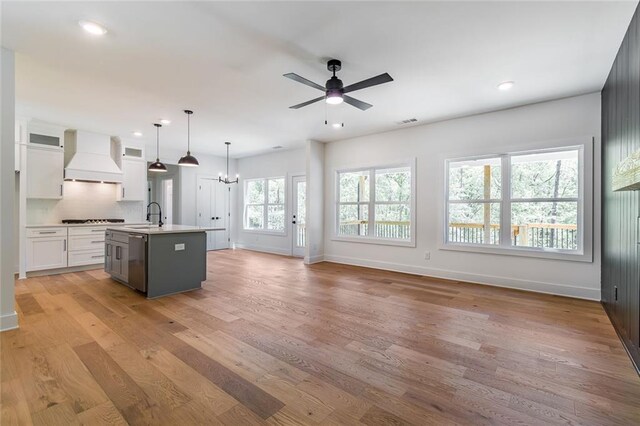 6073 Rockingham Way, Gainesville, GA 30506 - kitchen featuring baseboards, white cabinetry, black cooktop, and custom exhaust hood