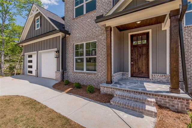6073 Rockingham Way, Gainesville, GA 30506 - doorway to property with board and batten siding, driveway, and brick siding