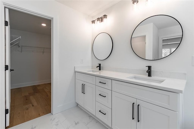 6073 Rockingham Way, Gainesville, GA 30506 - bathroom with a sink, a spacious closet, double vanity, and marble finish floor