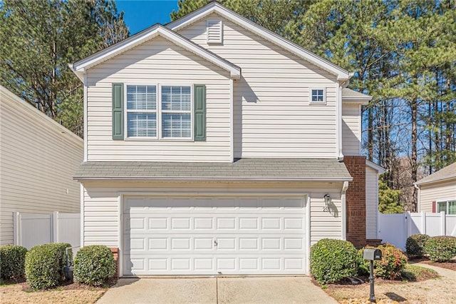 view of front of home with an attached garage, driveway, roof with shingles, and fence