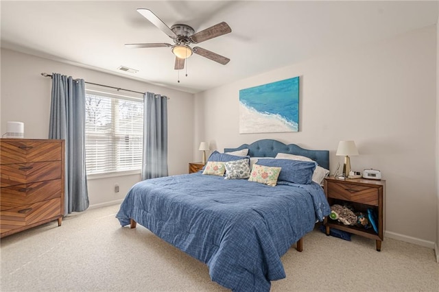 bedroom featuring light carpet, visible vents, a ceiling fan, and baseboards