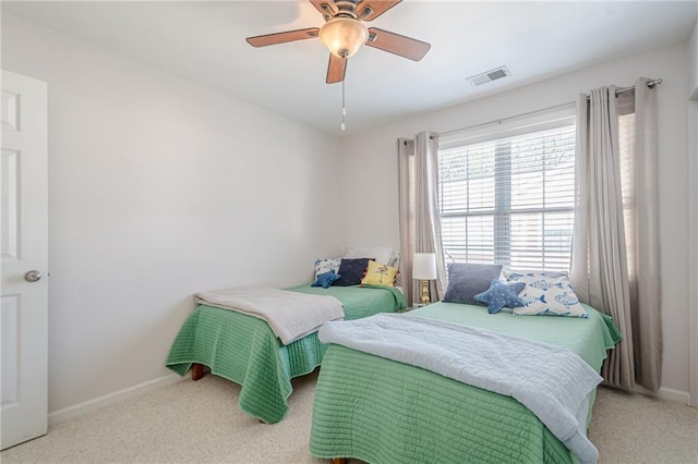 bedroom featuring visible vents, baseboards, carpet, and a ceiling fan