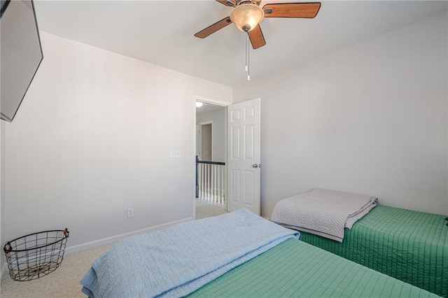 carpeted bedroom with baseboards and ceiling fan