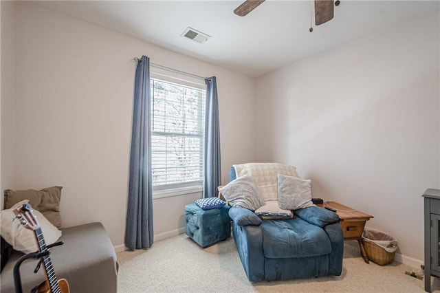 sitting room with visible vents, baseboards, ceiling fan, and carpet flooring