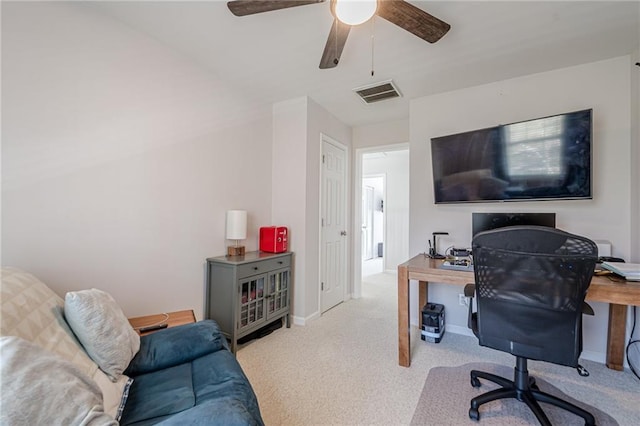 carpeted home office featuring visible vents, baseboards, and a ceiling fan