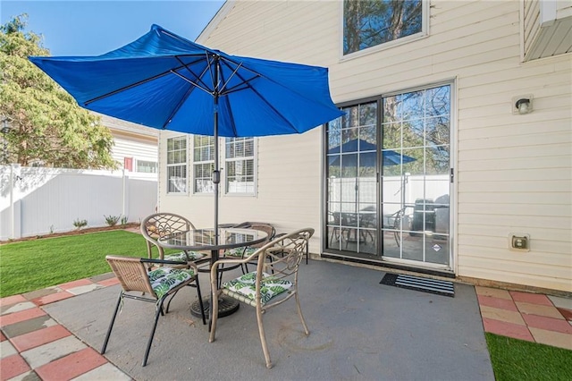 view of patio / terrace with outdoor dining space and fence