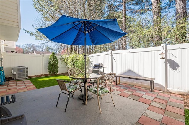 view of patio with a fenced backyard, central AC, and outdoor dining space