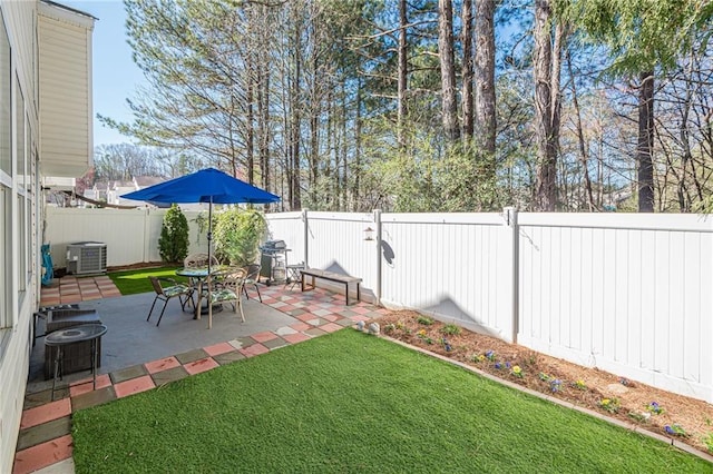 view of yard featuring a patio area, central air condition unit, and a fenced backyard