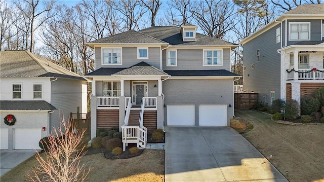 view of front of home featuring a front lawn, covered porch, and a garage