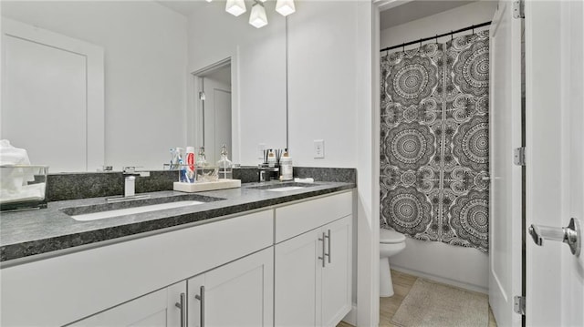 full bathroom with vanity, shower / bath combination with curtain, and toilet