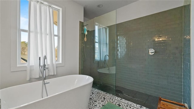 bathroom with tile patterned flooring, separate shower and tub, and plenty of natural light