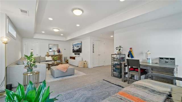 living room with light carpet and a tray ceiling