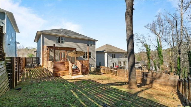 back of house with a yard and a wooden deck