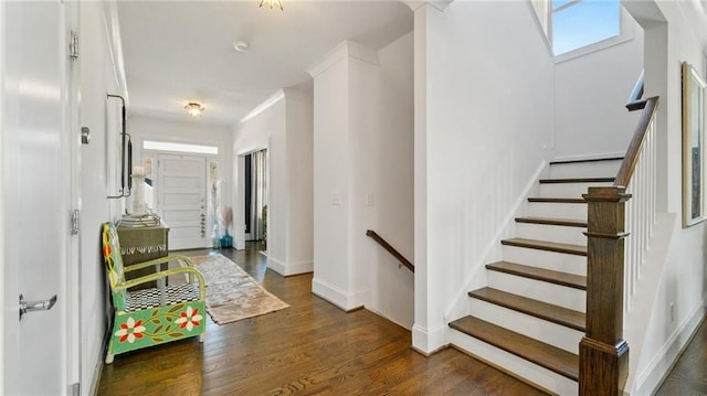 entryway featuring crown molding and dark wood-type flooring