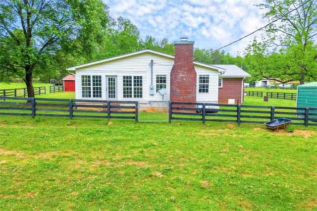 back of property featuring a yard