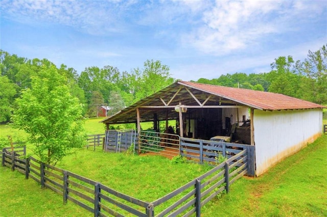 view of horse barn with a yard, an outdoor structure, and a rural view