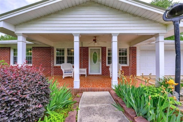 doorway to property with a garage and ceiling fan