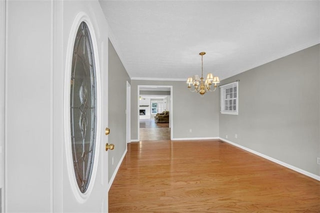 interior space with a notable chandelier, ornamental molding, and tile floors