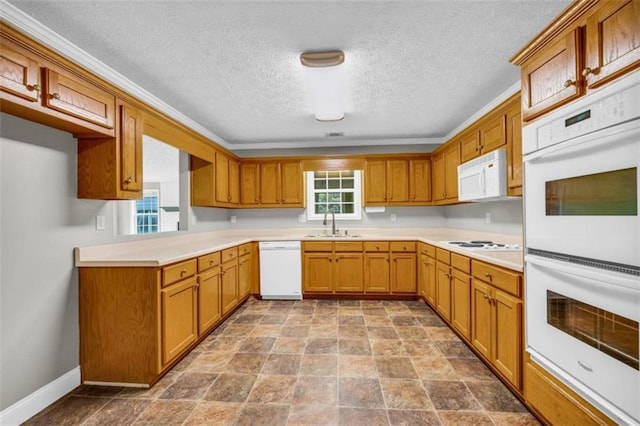 kitchen featuring tile flooring, white appliances, a textured ceiling, sink, and ornamental molding